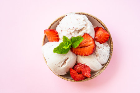 Homemade ice cream with fresh strawberries on pink background.の写真素材