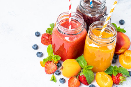 Smoothie with fresh fruits and berries at white background.の写真素材
