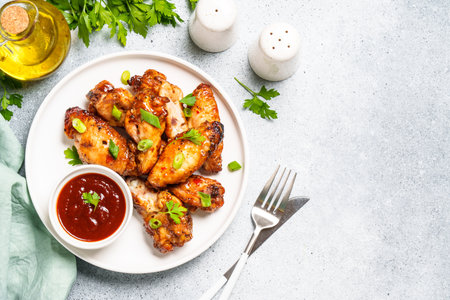 Chicken wings in bbq sauce at white table.の写真素材