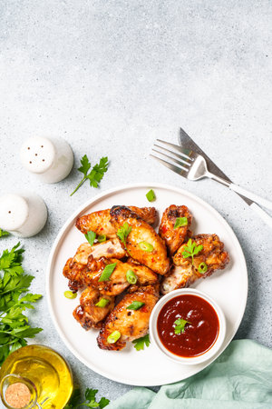 Chicken wings in bbq sauce at white table.の写真素材
