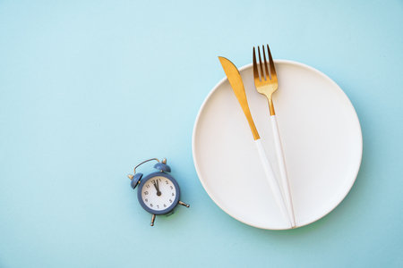 Intermittent fasting concept. Top view on blue.の写真素材