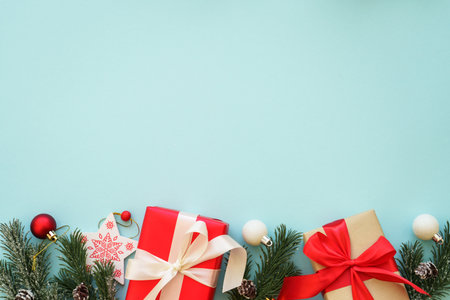 Christmas Present and red decorations at color background.の写真素材