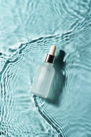 Serum bottle in the water on blue.の写真素材