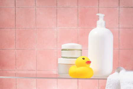 Cosmetic products at glass shelf at pink bathroom background.の写真素材