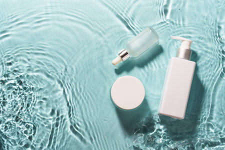 Natural cosmetic products in the water with waves on blue.の写真素材