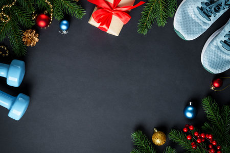 Christmas holidays decorations and sport equipment at black background.の写真素材