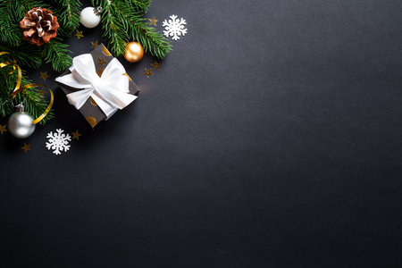 Black christmas background. Christmas present with golden decorationsの写真素材