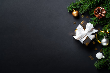 Black christmas background. Christmas present with golden decorationsの写真素材