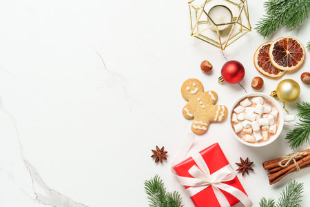 Hot cocoa, spices and gingerbread man with holiday decorations.の写真素材