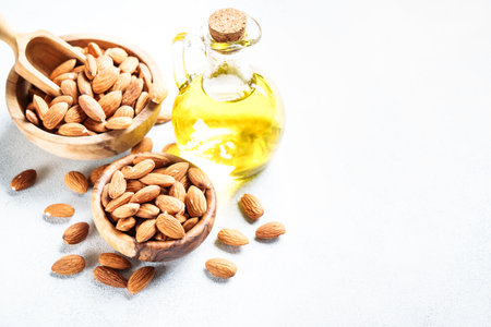 Almond nuts in wooden bowl at white background.の写真素材