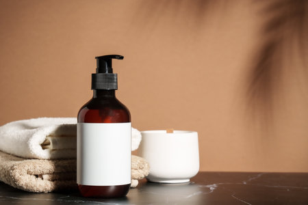 Shampoo bottle or liquid soap with towels stack at marble table.の写真素材