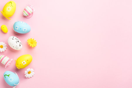 Easter background with colored eggs on pink background. Top view image.の写真素材