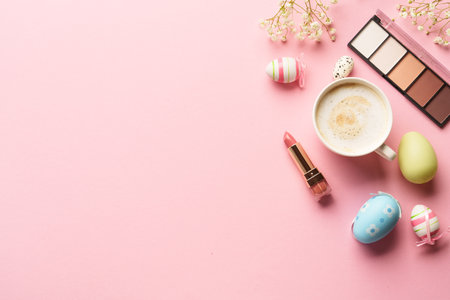 Woman flat lay background. Eyeshadow, lipstick, flower and cup of coffee.の写真素材
