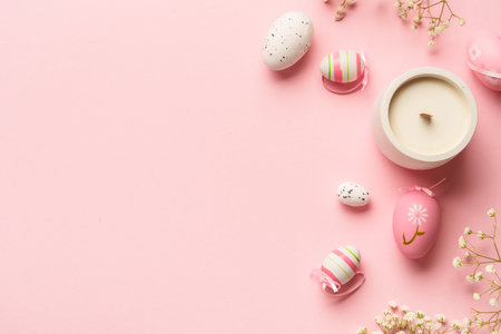 Easter background flat lay on pink. Colored eggs and flowers with copy space.の写真素材