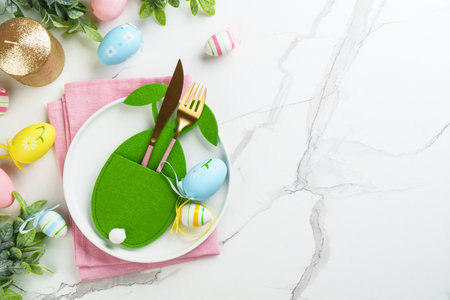 Easter food with decorations on white background. White plate, cutlery and funny easter decorations.