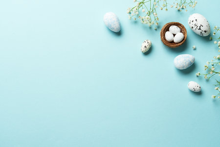 Easter background with eggs and flowers. Flat lay on blue background.の写真素材