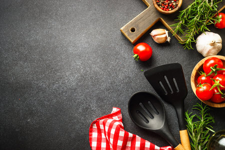 Food background on black. Fresh herbs, spices and vegetables with tablecloth.の写真素材