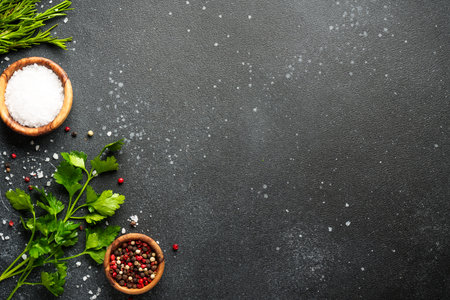 Food cooking ingredients. Herbs and spices on black kitchen table.の写真素材