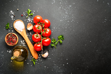 Kitchen table with ingredients for cooking.. Organic vegetables, olive oil, herbs and spices on black.の写真素材