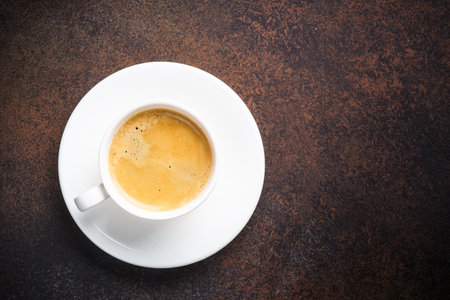 Cup of coffee at dark table . Top view with copy space.の写真素材