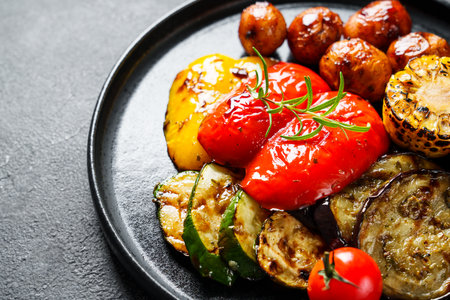 Grilled vegetables. Potato, paprika, zucchini, eggplants and tomato. Barbecue dish, vegetarian. Close up.の写真素材
