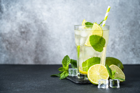 Mojito with rum and lime on black background. Tradition Summer drink with ice.の写真素材