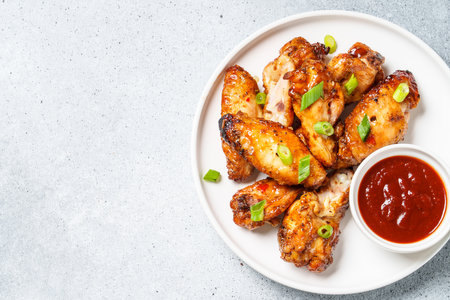 Chicken wings in bbq sauce. Meat dish. Top view on white stone table.の写真素材