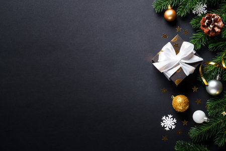 Black christmas background. Christmas present with golden decorations, elegant modern styleの写真素材