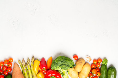 Healthy food, vegan food. Fresh vegetables on white background. Paprika, asparagus, tomatoes, broccoli. Top view on white.の写真素材