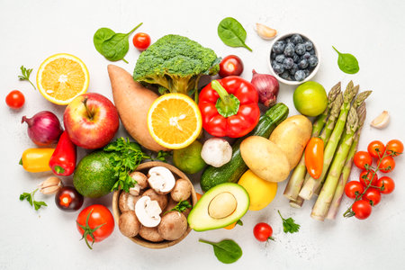 Healthy food on white background. Fresh vegetables, fruits and nuts. Flat lay with copy space.の写真素材