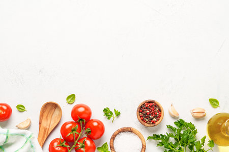 Spices, herbs and vegetables with olive oil on white kitchen table. Flat lay image with copy space.の写真素材