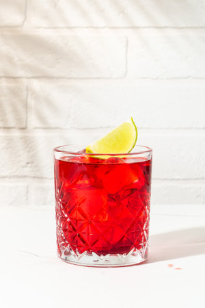 New Yorker red cocktail with whiskey, grenadine, bitter, lime and ice in glass.の写真素材