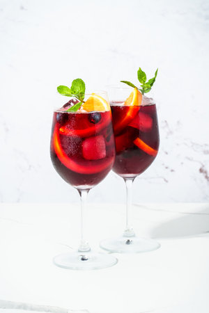Sangria with fresh fruits and ice. Summer alcohol drink on white background.の写真素材