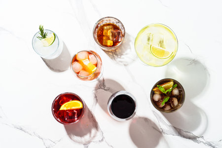 Cocktail party, Alcohol cocktail drinks. Whiskey, margarita, Aperol spritz, Cuba libre, red wine, negroni, sangria and jin tonic at white background. Top view.の写真素材