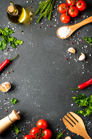 Food background with fresh vegetables, herbs and spices on black.の写真素材