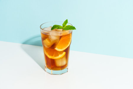 Iced tea, lemonade. Summer cold drink on colored background with hard shadows.