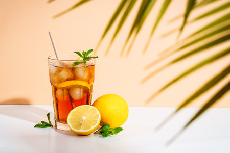 Iced tea, lemonade. Summer cold drink with sunglasses and tropical palms on sunny background.の写真素材