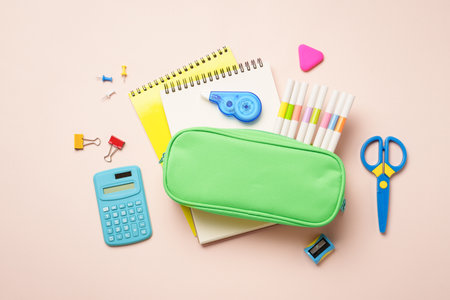 Pen il case, school supplies on colored background. Pencil case, notepads, markers, pens and others....