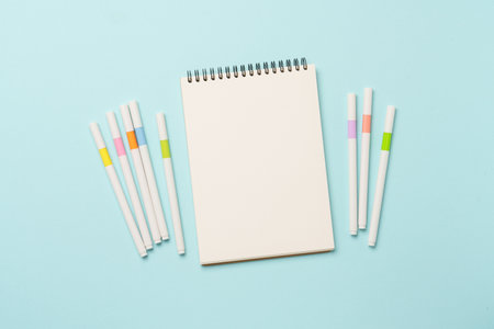 Sketch book and markers or colored liners. Accessories for drawing and creativity. Flat lay with...