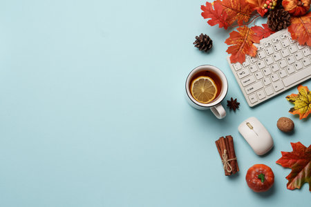 Autumn workspace flat lay background. Laptop, notebook, mug of tea and fallen leaves.