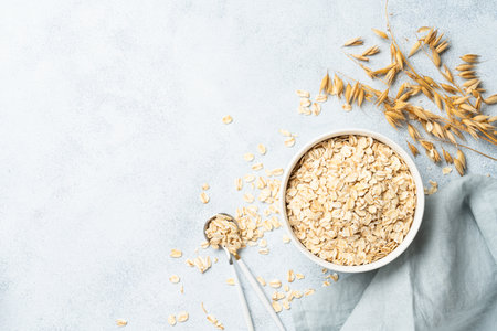 Rolled oats flakes in a wooden bowl.の写真素材