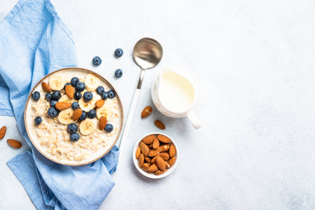 Oatmeal porridge with milk, bananas and blueberries.の写真素材