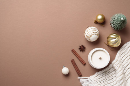 Mocha Mousse winter background. Christmas decor, candle and white knitting scarf. Cozy Flat lay composition with copy space.の写真素材