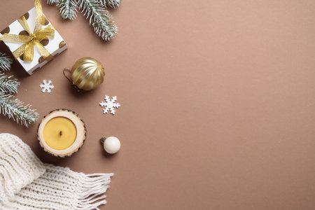 Cozy winter flat lay composition. Christmas decor, candle and white knitting scarf.の写真素材