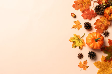 Autumn leaves, pumpkins, spices and fallen leaves on color background. Top view with space for text.