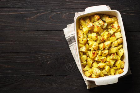Baked potato with thyme on dark rustic table. vegan dish. Top view with copy space.の写真素材