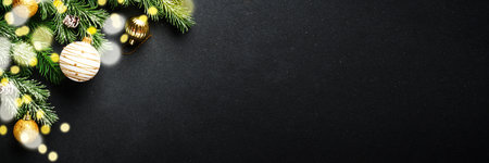 Christmas decorations and spruce tree at black background. Long banner format.