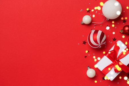 Christmas background with present box and holiday decorations on red. Flat lay image with copy space.の写真素材