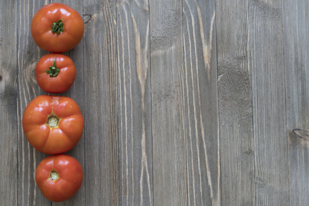 Tomatoes on a wooden backgroundの写真素材