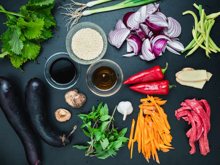 Various ingredients for a Japanese style stir fry dinner cooking on the kitchen counter.の写真素材